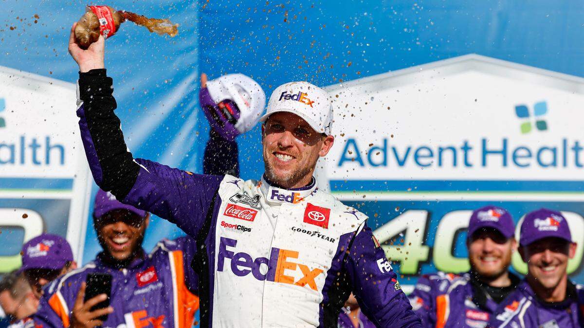 NASCAR Cup Series driver Denny Hamlin rejoices in victory lane after winning Sunday’s AdventHealth 400 race at Kansas Speedway in Kansas City, Kan.