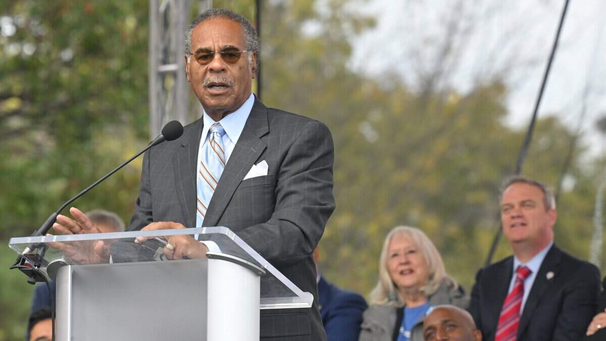 Rep. Emanuel Cleaver II, at podium spoke while Kansas City Mayor Quinton Lucas, seated at lower right, listened on Friday, Oct. 24, 2025, during the grand opening celebration for the KC Streetcar extension in Kansas City.
