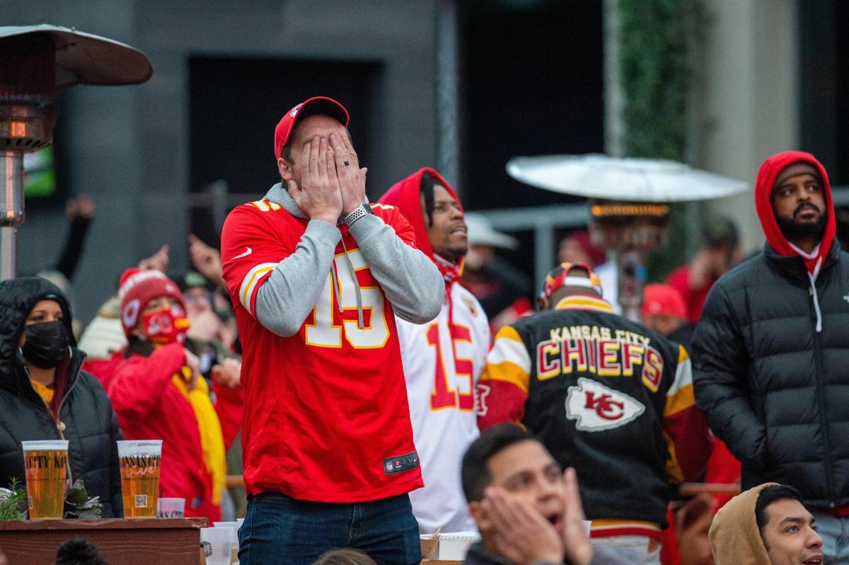 A Chiefs fan covers his face after backup quarterback Chad Henne threw an interception in the end zone in the fourth quarter of the game against the Cleveland Browns Sunday, Jan. 17, 2021.