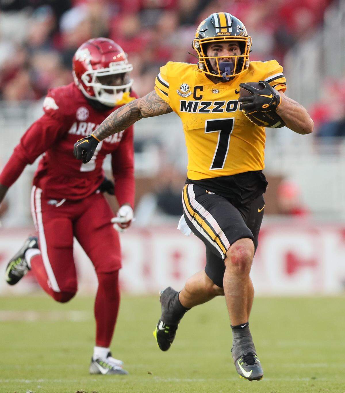 Missouri Tigers running back Cody Schrader, right, racked up huge rushing yardage against the Arkansas Razorbacks on Friday at Donald W. Reynolds Razorback Stadium in Fayetteville, Ark.