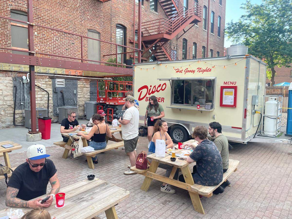 Disco Burger serves a menu of burgers, hot dogs, fries, and a sundae on the back patio at Varsity Club.