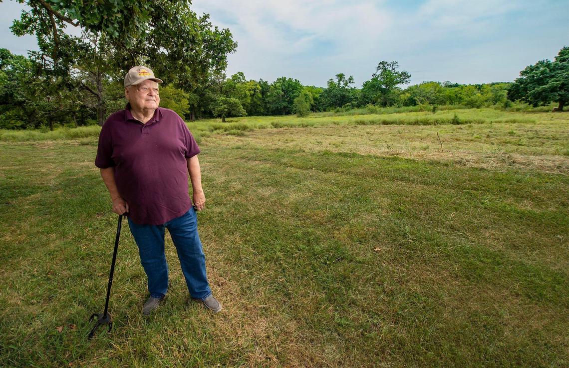 Larry Short of Independence, president of the national Santa Fe Trail Association, is working on events marking the 200th anniversary of the Santa Fe Trail this year. He is photographed near the swales created by the wagons that traveled through the area at Minor Park.