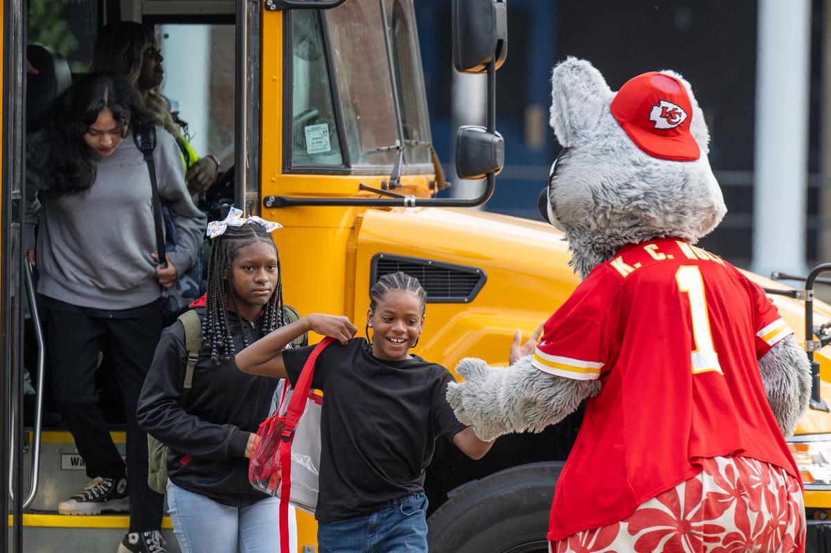 Kansas City Chiefs mascot K.C. Wolf greets students as they get off the bus, welcoming them to the first day of school at Central Middle School on Monday, Aug. 19, 2024, in Kansas City.