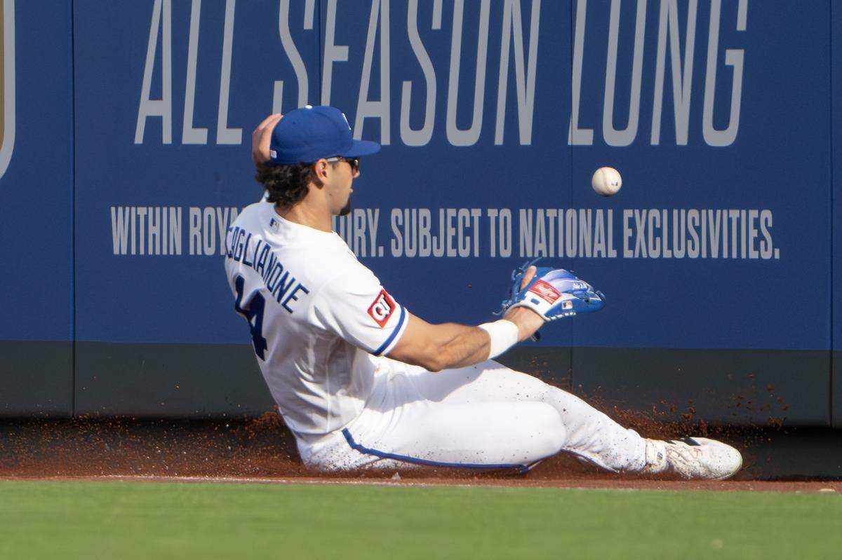 Kansas City Royals right fielder Jac Caglianone (14) slides to attempt to catch a ball in the eighth inning during the home opener game against the Minnesota Twins at Kauffman Stadium on Monday, March 30, 2026, in Kansas City.