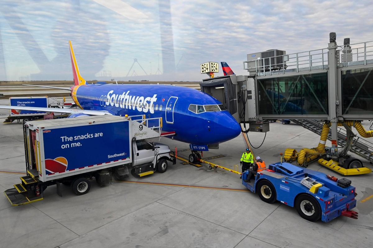 Ground crews greeted a Southwest Airlines jet, the first flight to land at the new $1.5 billion single terminal on Tuesday, Feb. 28, 2022, at Kansas City International Airport.