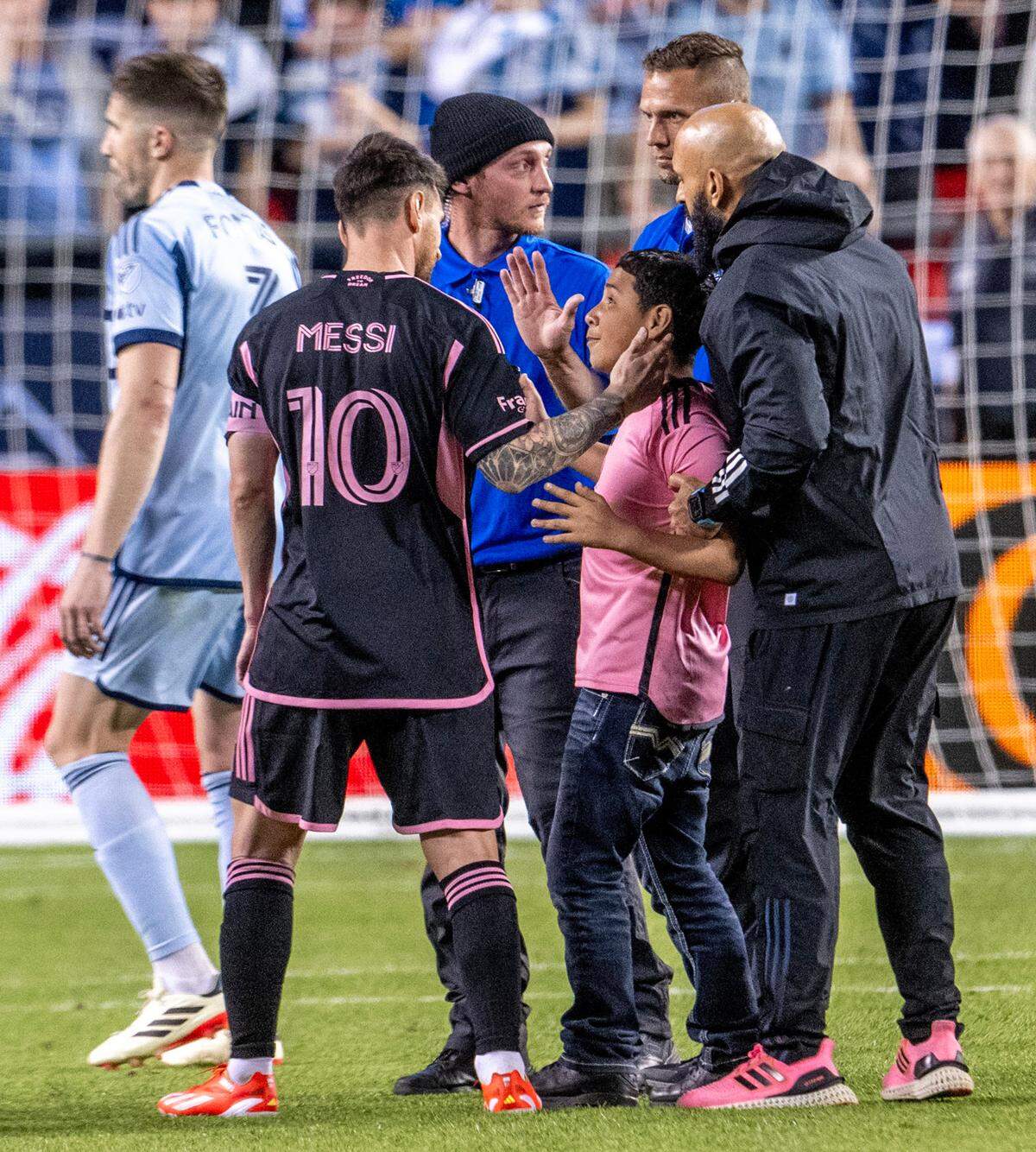 A young Inter Miami fan made it onto the field to take a photo with forward Lionel Messi (10) during a match against Sporting Kansas City at GEHA Field at Arrowhead Stadium. A chance to watch Messi, the soccer world’s biggest global superstar, helped pack in more than 72,000 fans at Arrowhead.