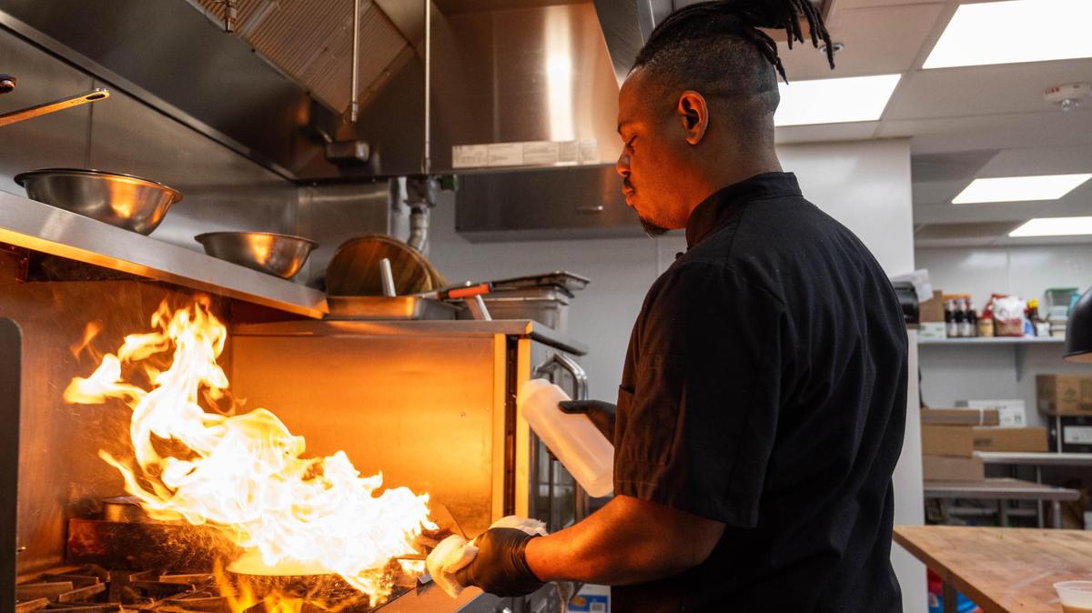 Chef Justin Clark preparing a dish at Urban Located at Armour Road and Troost Avenue, and included in the new “Savor The City” guide to Black-own KC restaurants.