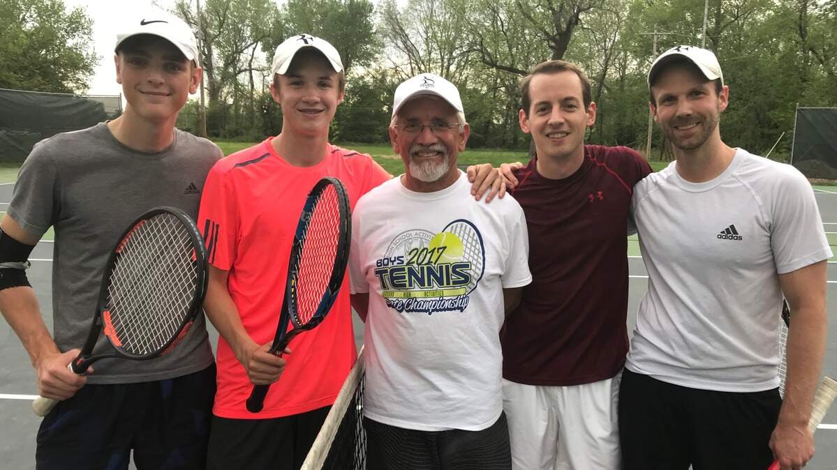 Bonner Springs tennis coach Bill Scott (center), who is retiring after 40 years, is flanked by his current state-qualifying team of Foster Hoch (left) and Coleton Nelson and his 2005 state championship team, Josh Mortensen and Matt Kerl (right).