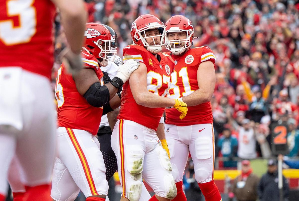 Kansas City Chiefs tight end Travis Kelce (center) celebrates a touchdown with teammates during the playoff game against the Jacksonville Jaguars at GEHA Field at Arrowhead Stadium on Saturday, Jan. 21, 2023, in Kansas City.