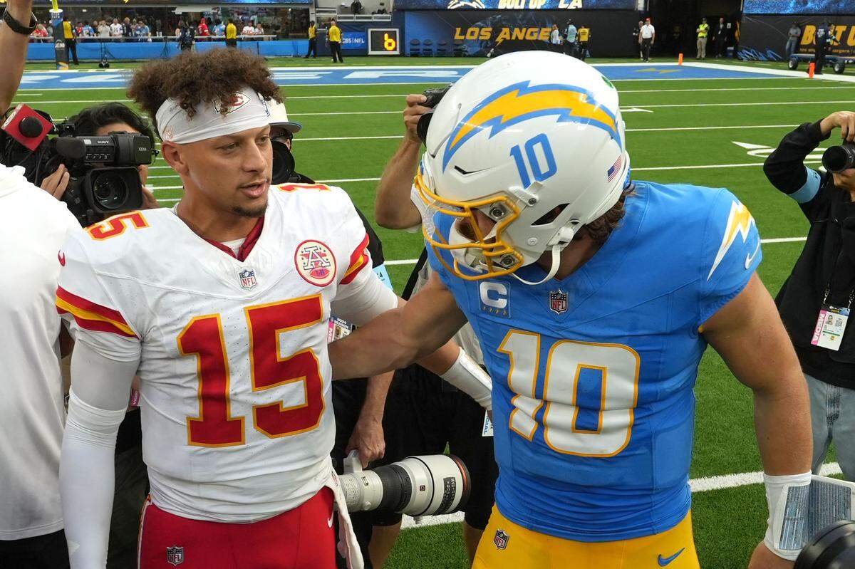 Kansas City Chiefs quarterback Patrick Mahomes (15) and Los Angeles Chargers quarterback Justin Herbert (10) shake hands after a game at SoFi Stadium.