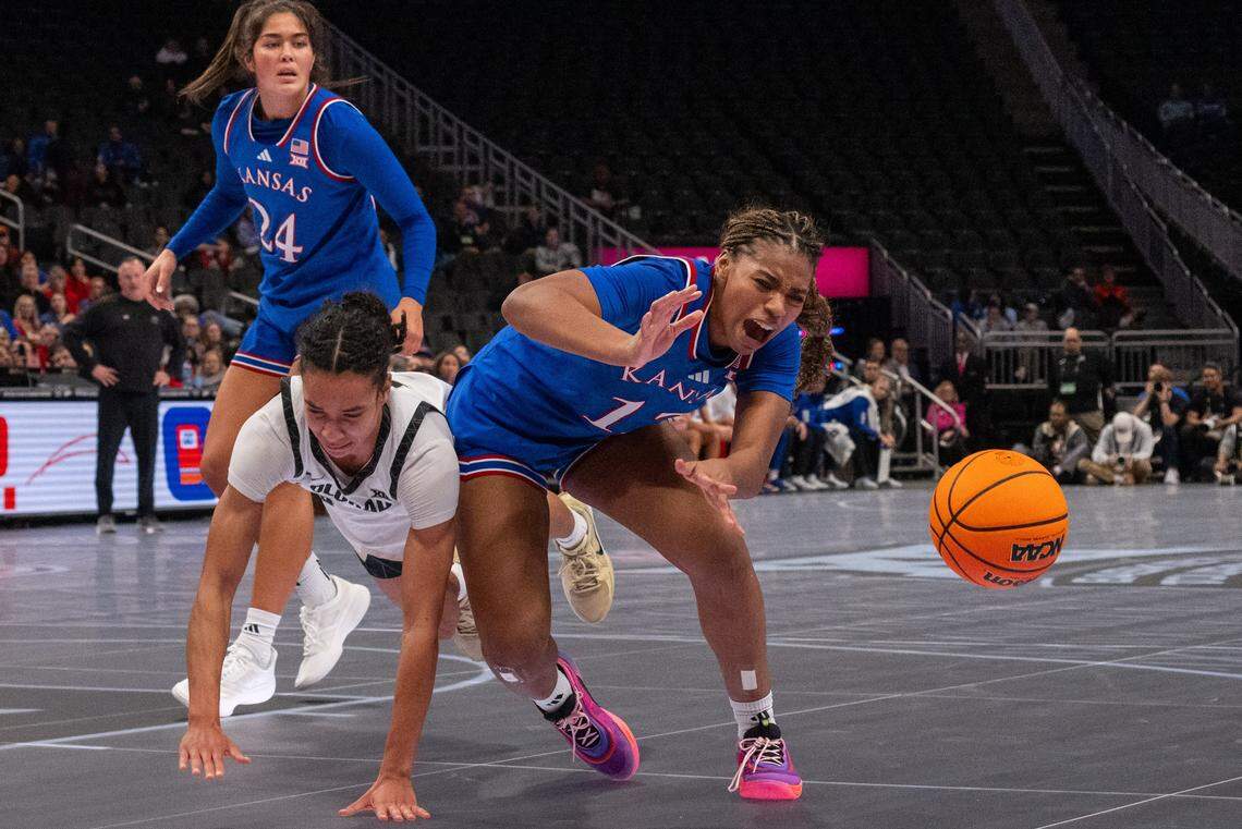 Kansas Jayhawks guard S'mya Nichols (12) is fouled on a drive to the basket in the first half of the Jayhawks first round game of the Big 12 Women's Basketball Tournament on Thursday, March 5, 2026, at T-Mobile Center.