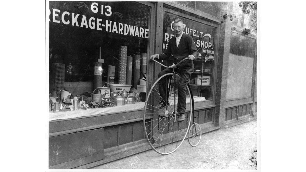 Man Riding a High Wheel Bicycle in Kansas City, c. 1920. (Zeldin Collection of Journal-Post Glass Negatives, Missouri Valley Special Collections.)