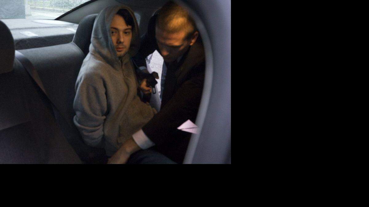 Martin Shkreli is belted into an awaiting car after being taken into custody following a securities probe, on Thursday, Dec. 17, 2015 in New York.
