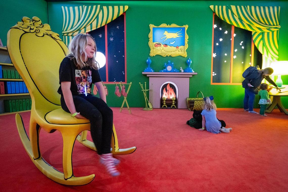 Osa Harper, 10, of Kansas City, sits in the giant rocking chair in The Great Green Room from “Goodnight Moon” at the Rabbit hOle museum.