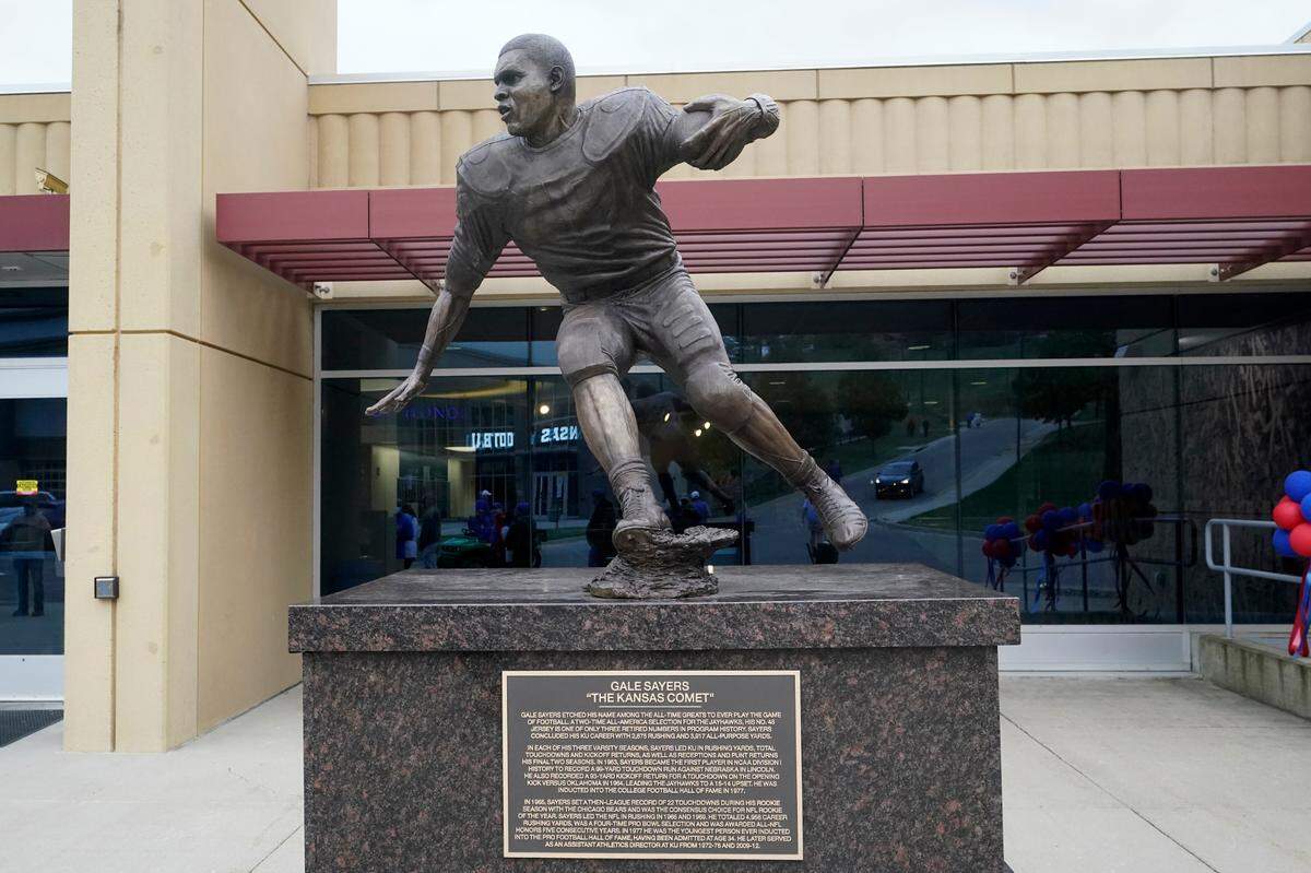 This statue of Gale Sayers was dedicated during halftime of an NCAA college football game between Kansas and Oklahoma State in Lawrence, Kan., Saturday, Oct. 3, 2020. The statue is located in front of Anderson Family Football Complex located on the west side of Booth Memorial Stadium.