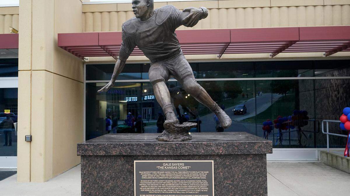 This statue of Gale Sayers was dedicated during halftime of an NCAA college football game between Kansas and Oklahoma State in Lawrence, Kan., Saturday, Oct. 3, 2020. The statue is located in front of Anderson Family Football Complex located on the west side of Booth Memorial Stadium.