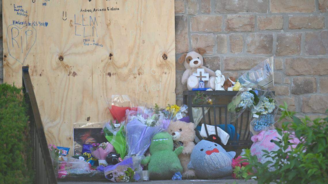 A memorial with flowers, stuffed animals and handwritten notes on a boarded door sits outside the Overland Park apartment where a Saturday morning fire killed a brother and sister and injured three other members of their family. The memorial, pictured on Friday, April 24, is part of support and donations coming in for the family.
