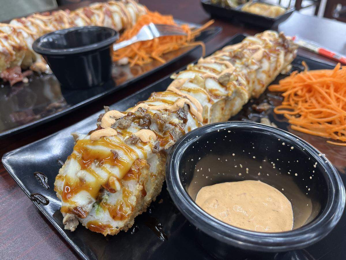 The Chiefs Roll (beef, chicken, avocado, melted cheese, cream cheese and eel sauce), a baked sushi roll at KCulichi Sushi ($16).