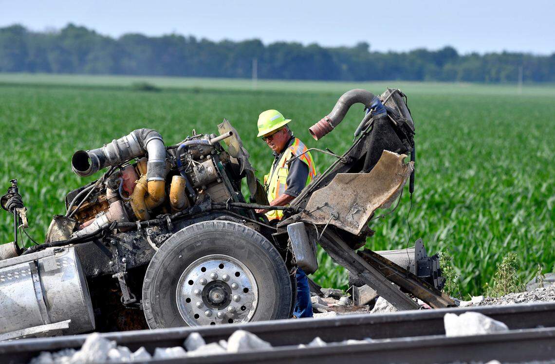 An investigator gathered notes at the intersection where parts of a dump truck struck by an Amtrak train came to rest near Mendon, Missouri, in June.