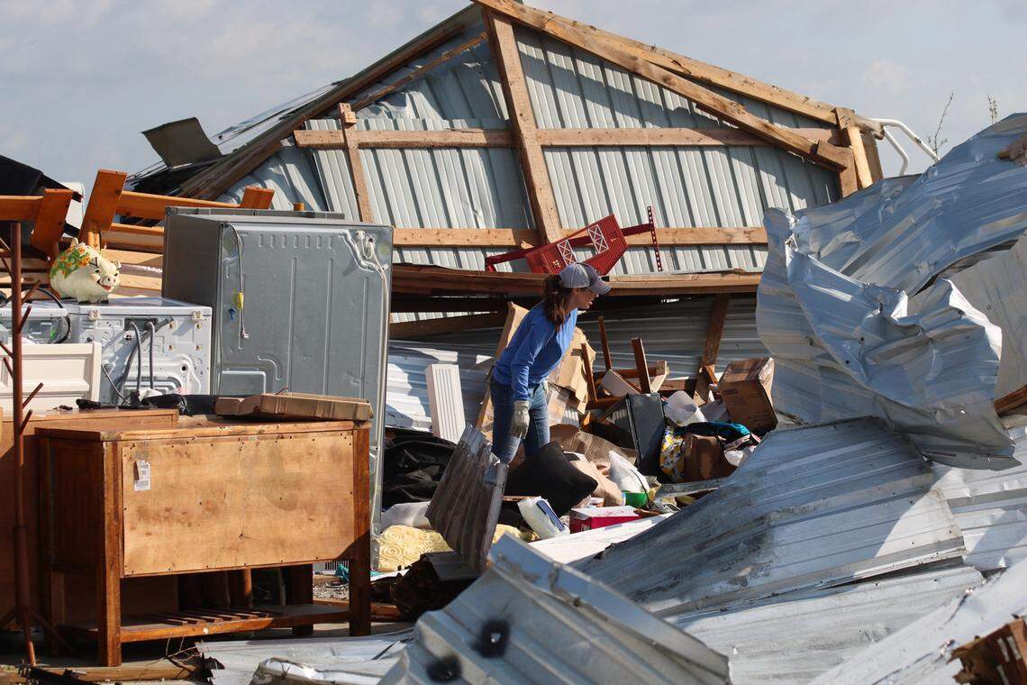 People look over items lost in a storm at Hillsdale Boat & Mini Storage on April 14, 2026 after a tornado ripped through the area the night before.
