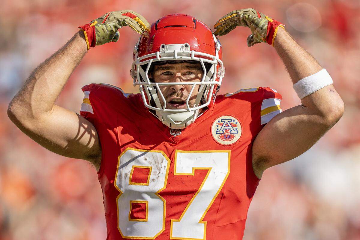 Kansas City Chiefs tight end Travis Kelce lifts his arms up after making a touchdown in the second quarter during an NFL game against the Denver Broncos on November 10, 2024, at GEHA Field at Arrowhead Stadium.