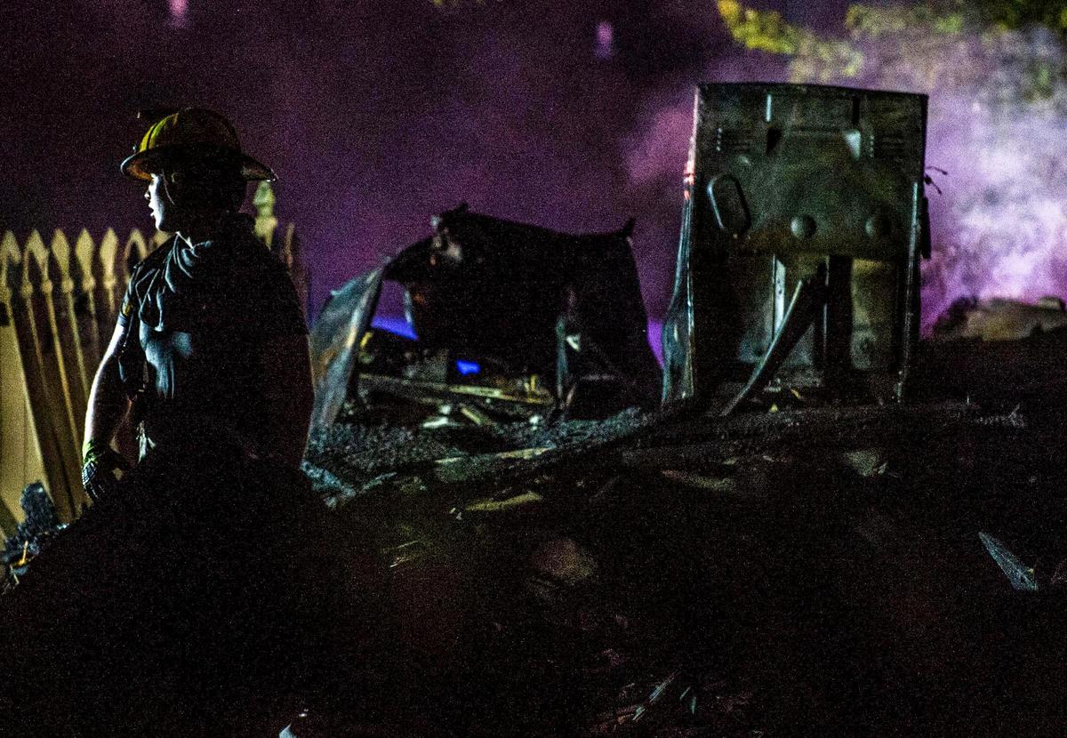 Raytown firefighters and police look over the scene after a duplex exploded in the 7500 block of Englewood Avenue, Monday, June 28, 2021 in Raytown. The cause of the fire is still under investigation.