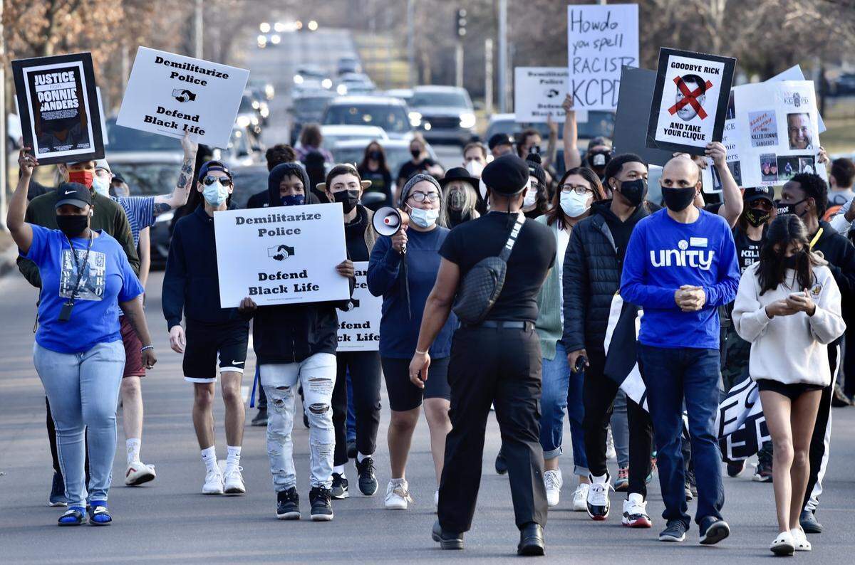 Justice for Donnie Sanders march heads north on Ward Parkway on Saturday, March 6, 2021. Earlier in the week, the Jackson County Prosecutor announced no charges would be filed against the officer who shot and killed Sanders nearly a year ago.