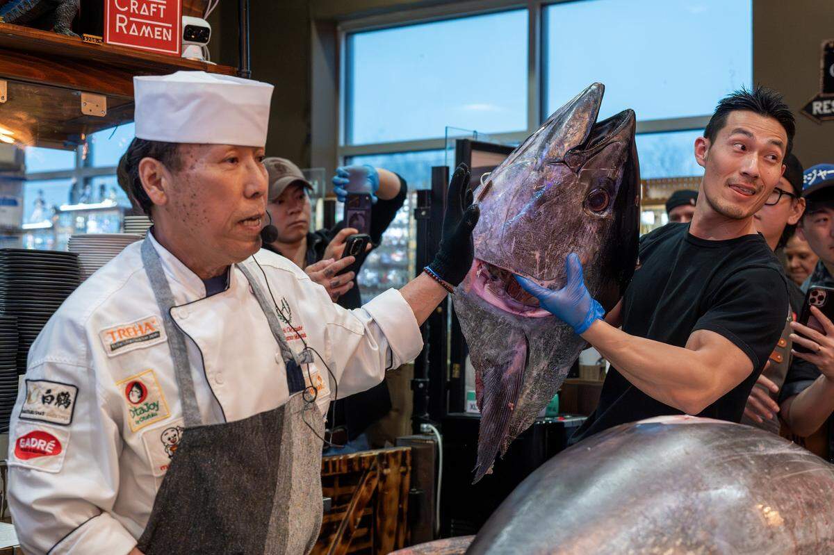 Chef Andy F. Matsuda, left, presents the head of a bluefin tuna as an assistant holds it during a cutting show at KC Craft Ramen on Monday, March 2, 2026, in Overland Park.