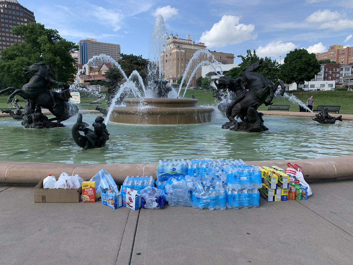 With temperatures in the low 90s, protesters at the J.C. Nichols Memorial Fountain came prepared Wednesday afternoon. Stashes of water bottles, juice and granola bars, along with milk and baking soda were in abundance.