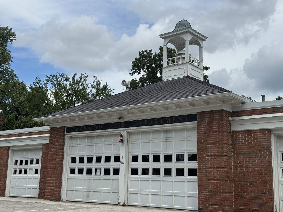 A brick building with white garage doors.