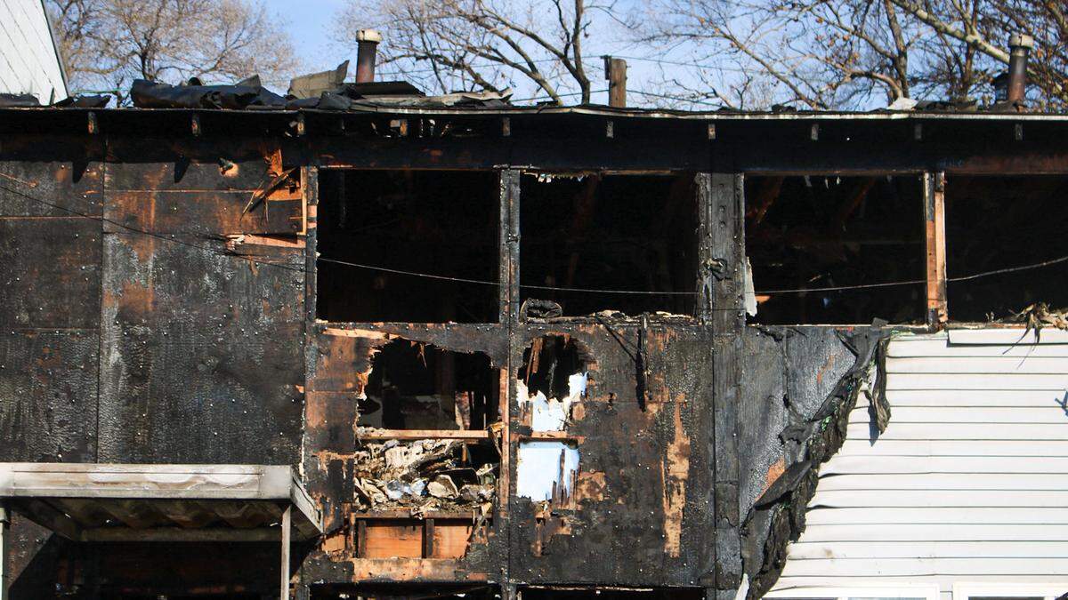 Windows are knocked out of a building scorched by fire at the Parade Park Homes complex. The Kansas City Fire Department has battled around 12 fires at the complex, which is set for demolition Dec. 15, 2025.