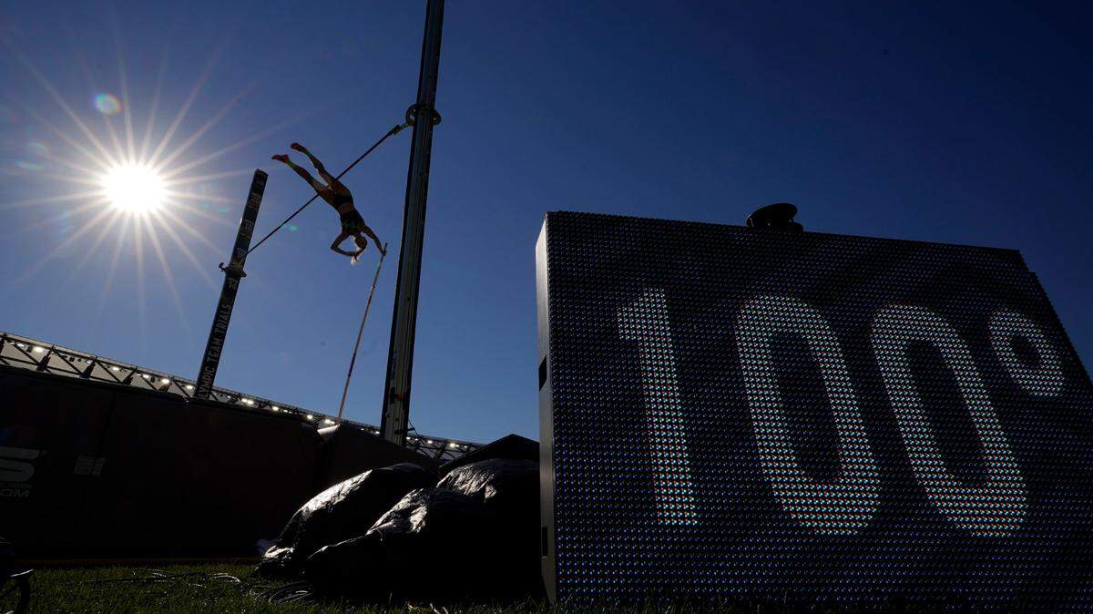 Olivia Gruver competes during the finals of the women’s pole vault near a sign displaying the temperature at the U.S. Olympic Track and Field Trials Saturday, June 26, 2021, in Eugene, Ore. (AP Photo/Charlie Riedel)