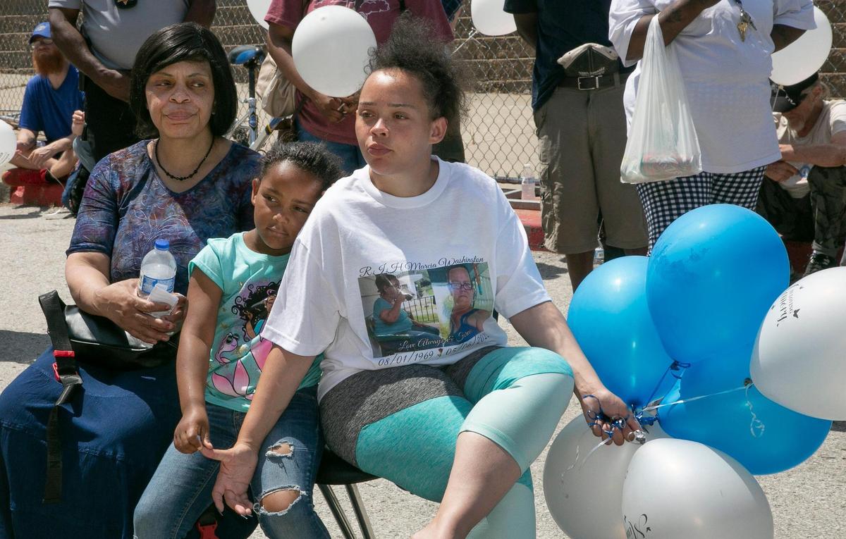 A memorial was held Friday at Hope Faith shelter for Marcia Boring, 52, and Eugene Shaw, 50, who were found dead last Friday in a wooded area near 2nd and Lydia Avenue. LeVada McHenry (left), Boring’s sister-in-law, Kemya Washington, 6, Boring’s granddaughter, and Kira Washington, Boring’s daughter, were in attendance.