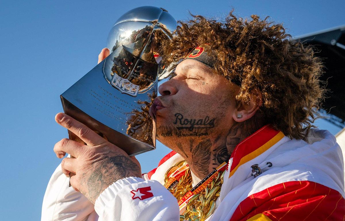Chiefs fan Scott Shepard of Kansas City, planted a kiss on a Lombardi Trophy while waiting for the Super Bowl LVIII championship parade and rally on Wednesday, Feb. 14, 2024, in Kansas City.