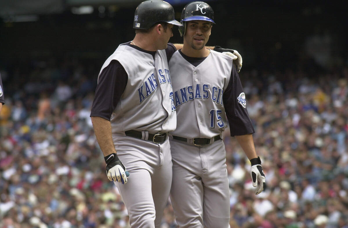 Kansas City Royals first baseman Mike Sweeney, left, puts his arm around center fielder Carlos Beltran after knocking him in with a first-inning homer during a game against the Mariners on Sept. 1, 2002 in Seattle.