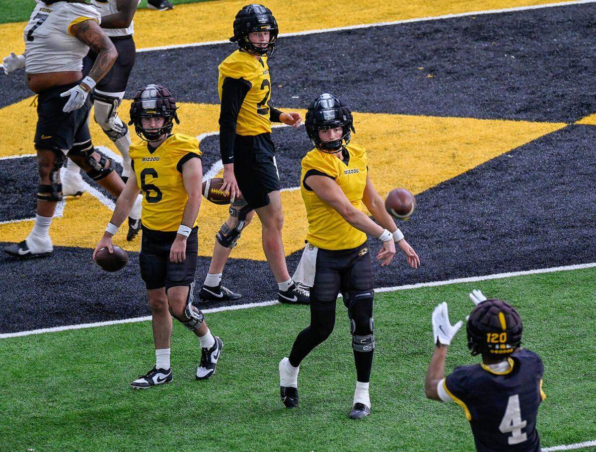 Mizzou quarterbacks Beau Pribula, right in gold, and Sam Horn, second from right in gold, take part in drills on the second day of spring practice March 1 at the Stephens Indoor Facility.