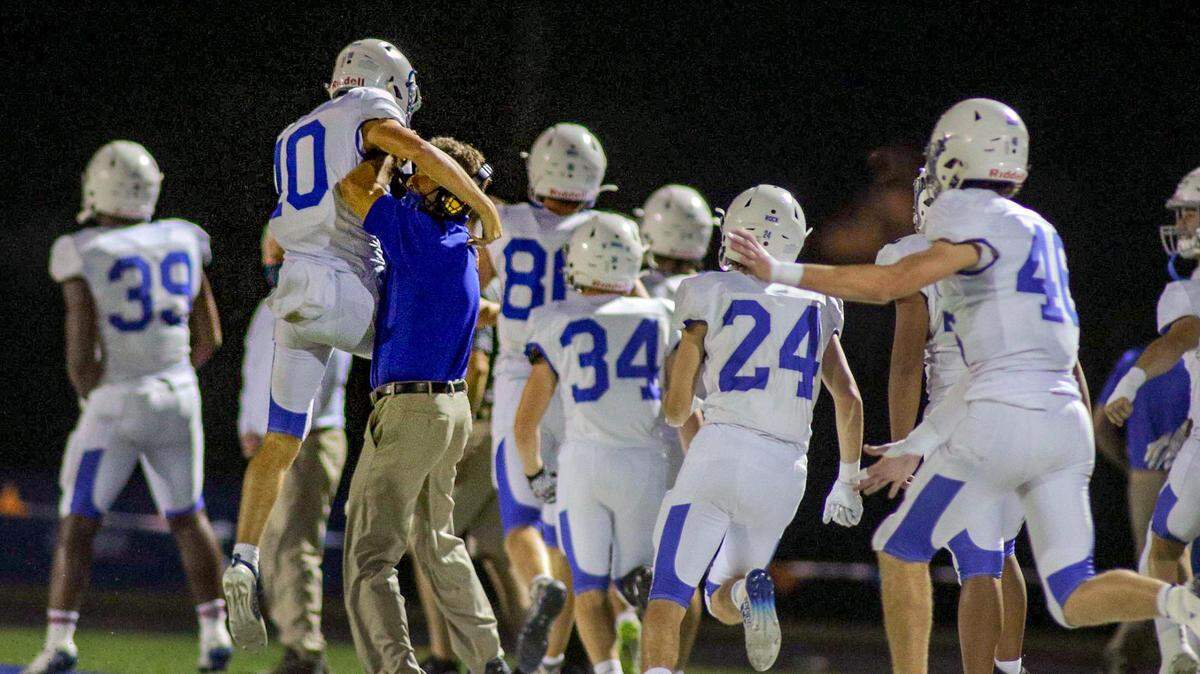 Rockhurst quarterback Bobby Hummel celebrates with head coach Kelly Donohoe after an 80-yard touchdown pass Friday night, Sept. 25, at Dixon Doll Stadium. That score helped the Hawklets take a 28-7 lead into halftime.