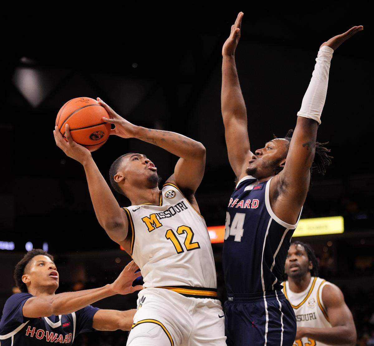 Missouri Tigers guard Tony Perkins, left, shoots over Howard Bison guard Bryce Harris during MU’s home basketball opener at Mizzou Arena in Columbia, Mo., on Friday, Nov. 8, 2024.