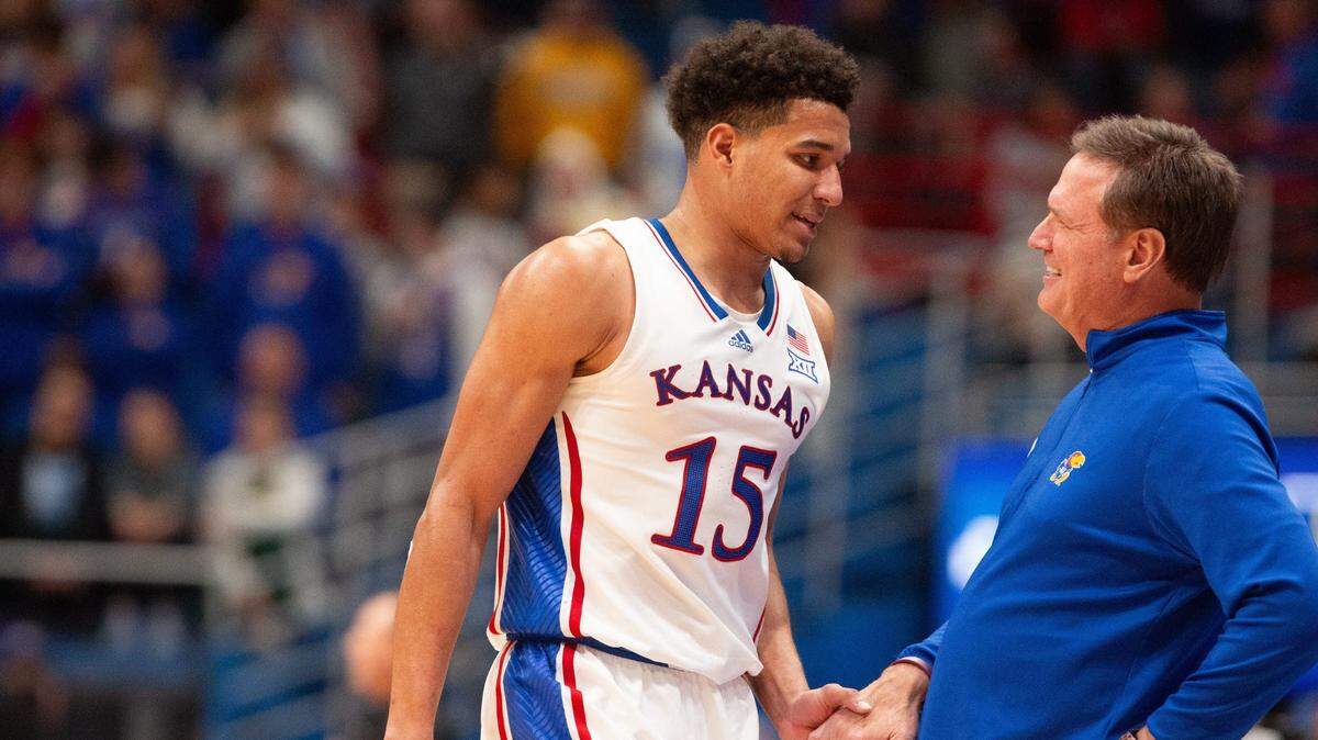Kansas guard Kevin McCullar Jr. (15) exchanges words with coach Bill Self after being pulled back to the bench during the second half of an exhibition game against Fort Hays State inside Allen Fieldhouse.