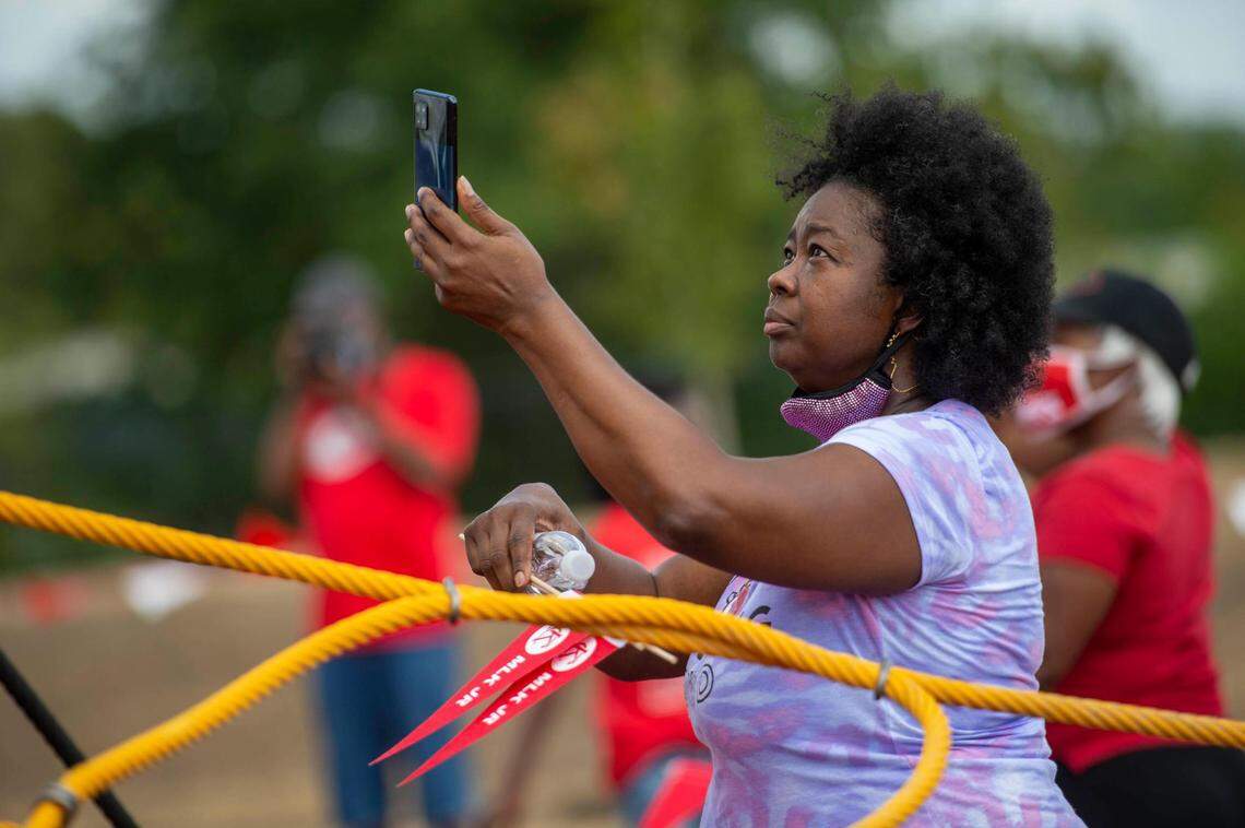 Rachel Walton of Kasnas City took photos of her daughter as she played at the new 15 and the Mahomies Playground at Martin Luther King, Jr. Park on Saturday, Aug. 28, 2021, at Dr. Martin Luther King, Jr. Blvd. & Woodland Ave., in Kansas City. Chiefs quarterback’s Patrick Mahomes foundation, 15 and the Mahomies Foundation donated $1 million to help transform the park making it accessible for children of all abilities.