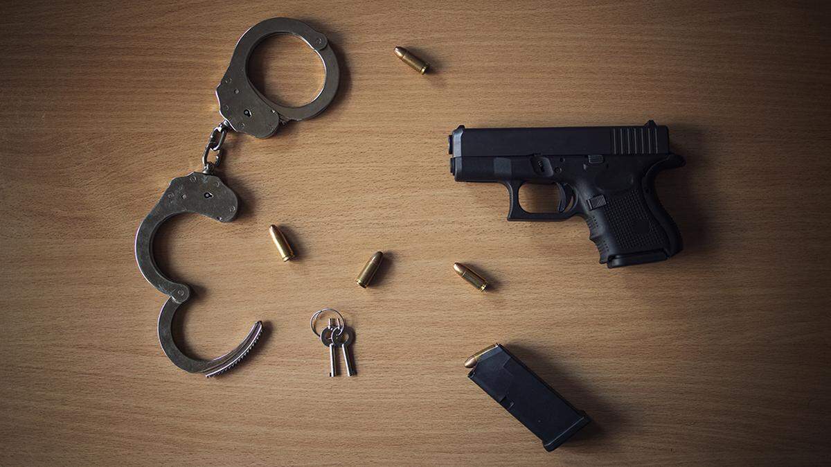 Top view of firearm, bullets and handcuffs. Police equipment.