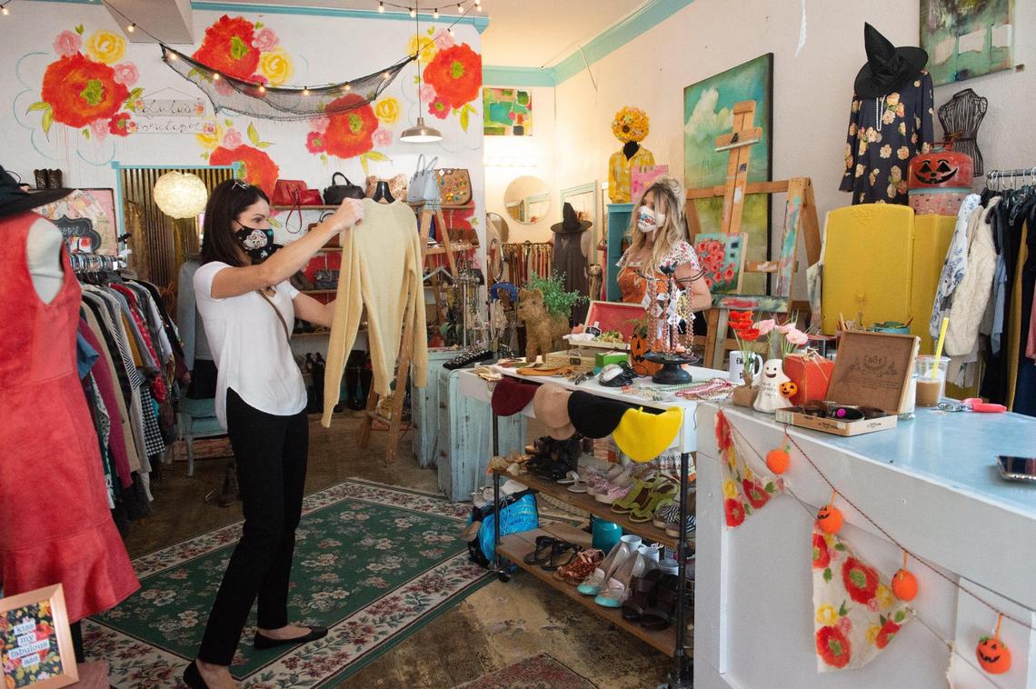 Jennifer Bricker-Pugh, right, who owns Lulu’s Boutique, a high end consignment shop in downtown Mission, chatted with a customer on a slow Thursday afternoon.