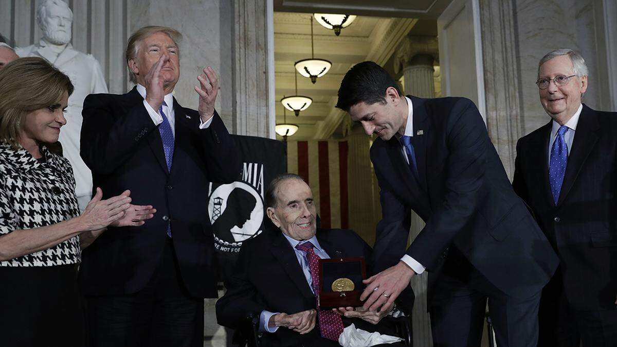 House Speaker Paul Ryan presents the Congressional Gold Medal to former Sen. Bob Dole on Capitol Hill, Wednesday, Jan. 17, 2018, in Washington. Watching from left are Rep. Lynn Jenkins, President Donald Trump and Senate Majority Leader Mitch McConnell.