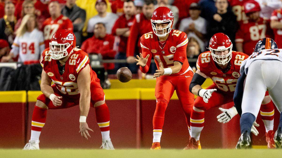 Kansas City Chiefs quarterback Patrick Mahomes (15) receives a snap from center Creed Humphrey (52) during an NFL football game against the Denver Broncos at GEHA Field at Arrowhead Stadium on Thursday, Oct. 12, 2023, in Kansas City.