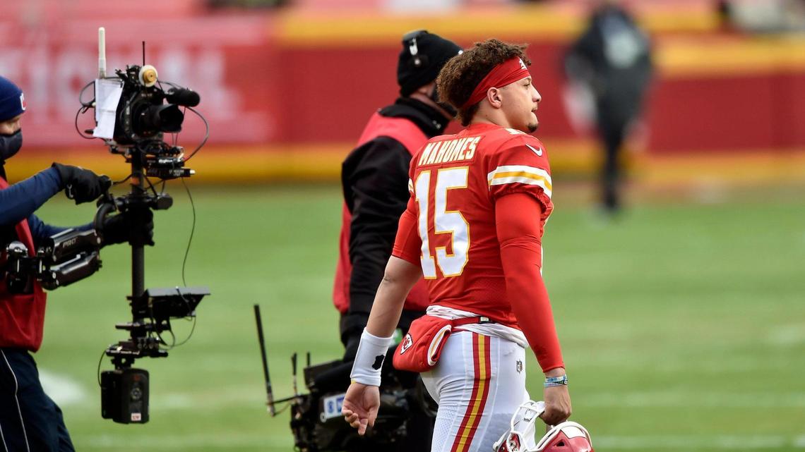 Media crews follow Kansas City Chiefs quarterback Patrick Mahomes to the sideline after the coin toss before the AFC Divisional Playoff game between the Chiefs and the Cleveland Browns at Arrowhead Stadium Sunday, Jan. 17, 2021. The Chiefs defeated the Browns 22-17.