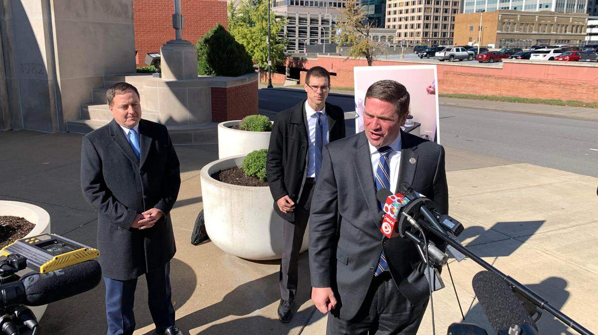 Missouri Attorney General Andrew Bailey speaks to reporters on Monday in Kansas City as Missouri Secretary of State Jay Ashcroft, left, watches.