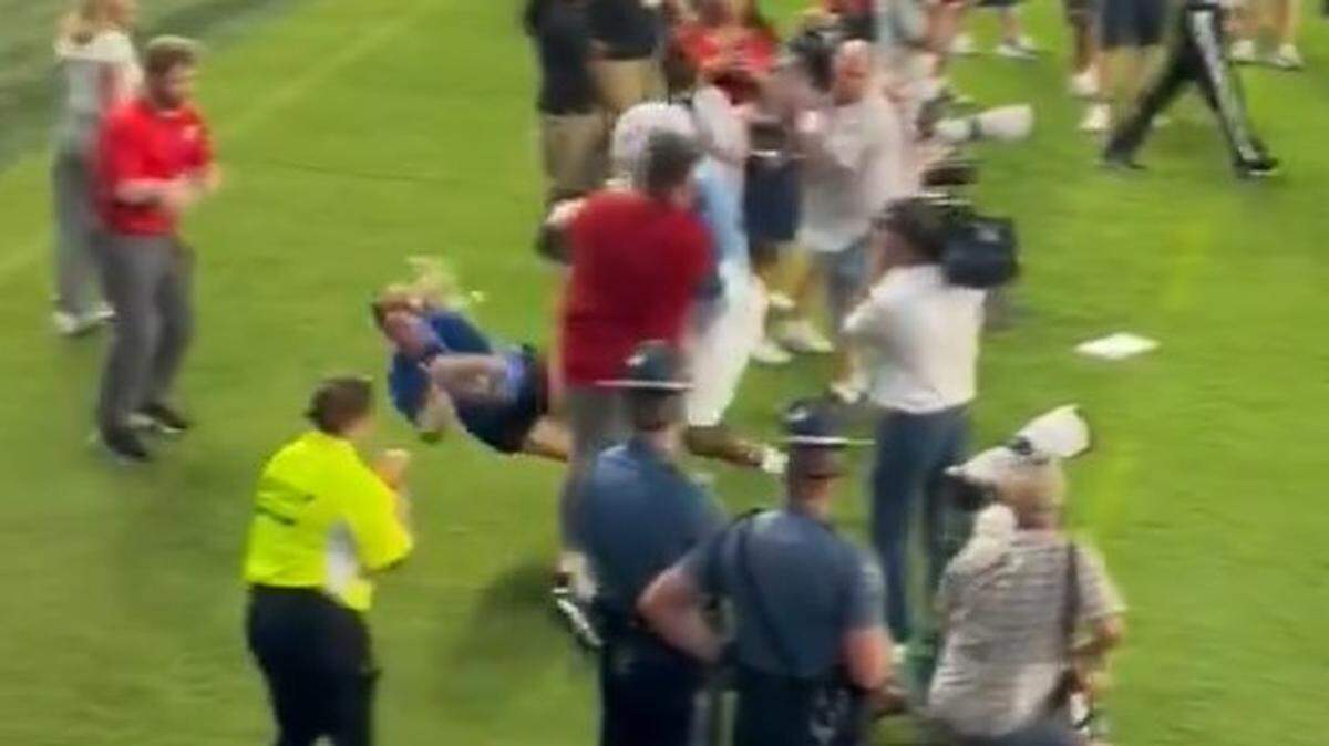 KU’s Daniel Hishaw knocked a fan on the sideline to the ground.