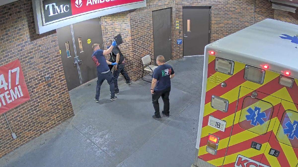 A frame grab from a security video shows an emergency medical technician with the Kansas City Fire Department assaulting a patient the EMT had helped transport to University Health Truman Medical Center in 2021.