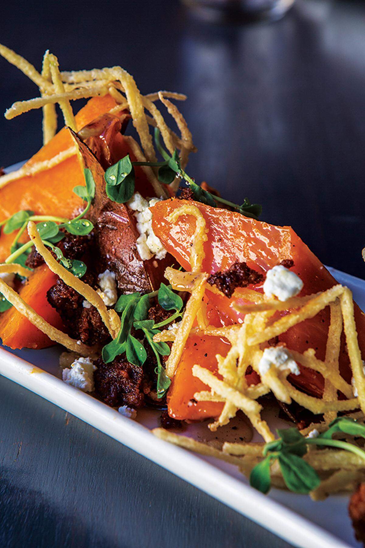 Chef Michael Foust layers sweet potato with spicy chorizo, fresh cheese, garlic honey and an herb drizzle.