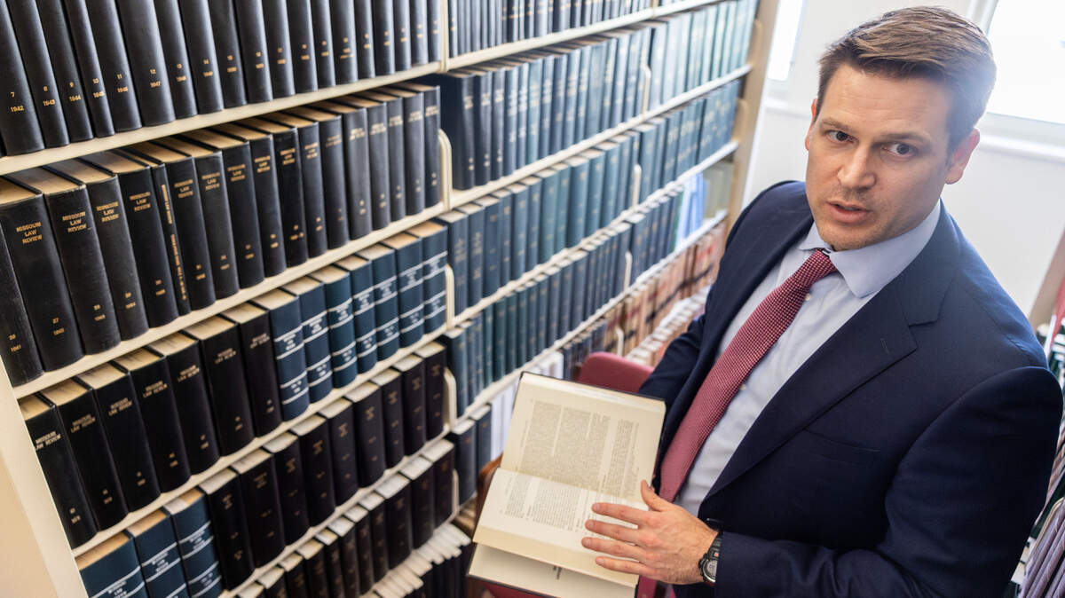 Shawn Lee, a Kansas City-based attorney, pages through a journal in the Jackson County Law Library’s downtown Kansas City location.